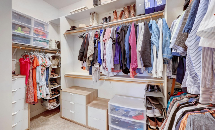 Oversized primary closet with lots of storage