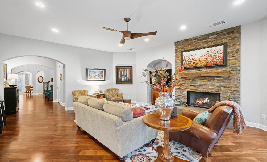 Family Room features gas fireplace open to the kitchen and overlooks the backyard. TV conveys.