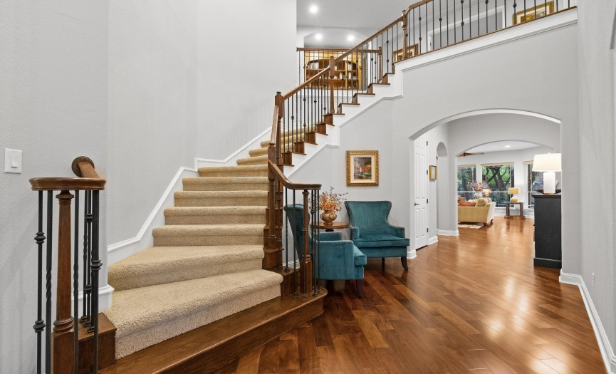 A welcoming spacious foyer features a grand staircase!