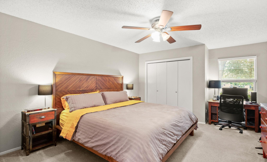 The warm and inviting primary bedroom offers a private ensuite bathroom and two separate closets. 