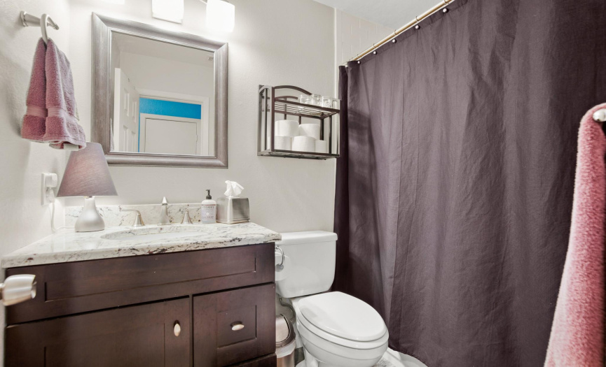 The full guest bathroom also offers a beautifully stained vanity with granite countertop and a shower/tub combo. 