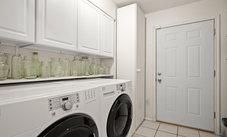The in-home laundry is located at the garage entry (mud room) and offers great cabinetry storage. The washer & dryer can stay or be removed. 