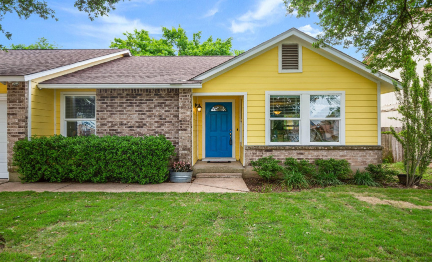Located on a quiet street with no through traffic, this dreamy home offers welcoming curb appeal with brick masonry, cheerful exterior paint, and beautiful shade trees.