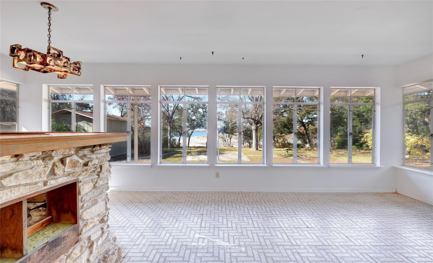 The sun porch has a wall of windows with sweeping lake views.