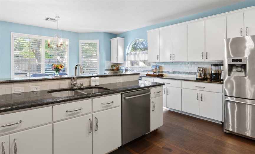 Clean, crisp, updated and upgraded throughout, the kitchen is a showplace. Plantation shutters, hardware, big windows.