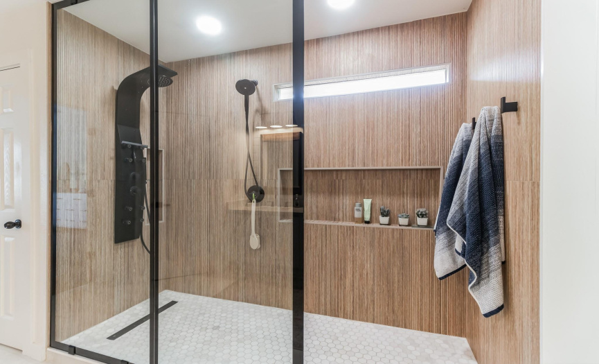 Stunning shower with massage jet stream shower system, dual shower heads and dry off area.