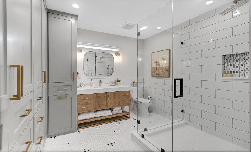 Bedroom 2 en-suite bathroom. Recently added. Custom closet cabinetry, penny tile floor design and large frameless shower.