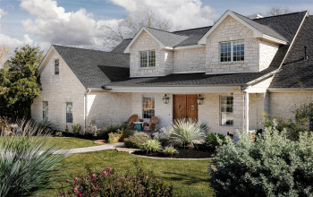 A striking stone facade and natural yet refined landscaping greet you.