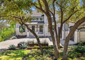 What beautiful curb appeal!  Texas Oaks and gorgeous landscaping allow for beauty and privacy!