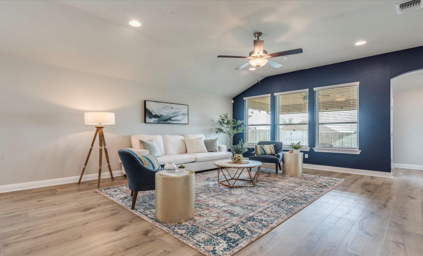 The welcoming living room offers an abundance of space to gather with friends and family.