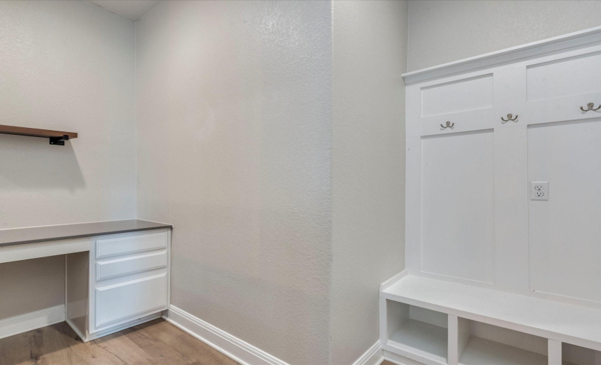 There’s also a charming mud room with a desk area and bench with coat hooks. 