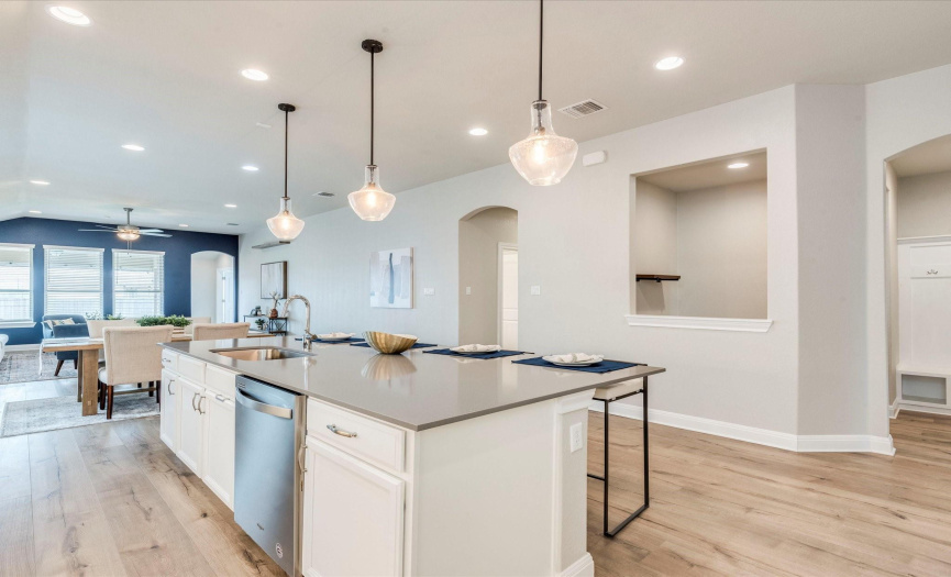 The oversized entertainer's kitchen island is lined with breakfast bar seating that everyone will want to gather around while you whip up your favorite culinary delights. 