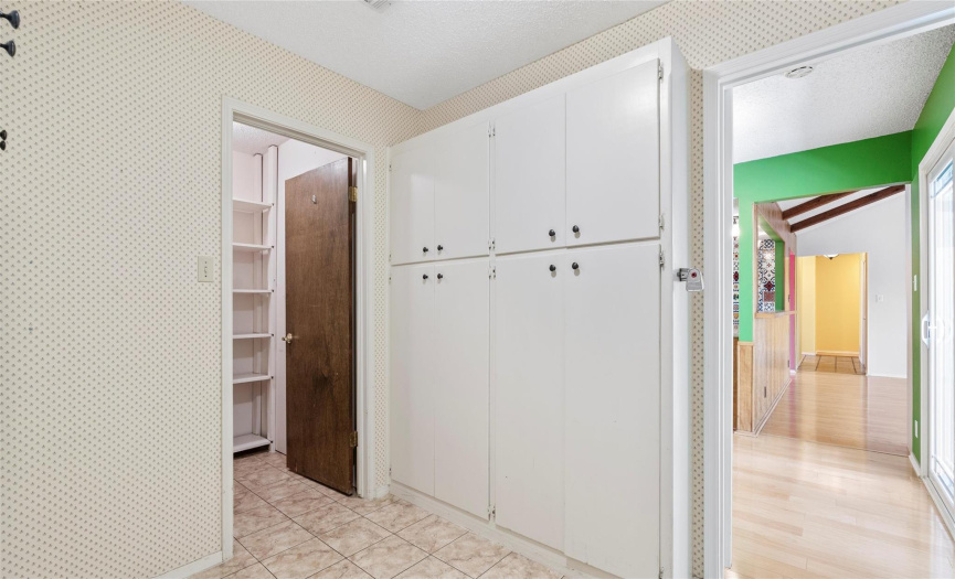 There is also a large in home laundry room with a walk-in pantry and extensive dry storage cabinetry. 