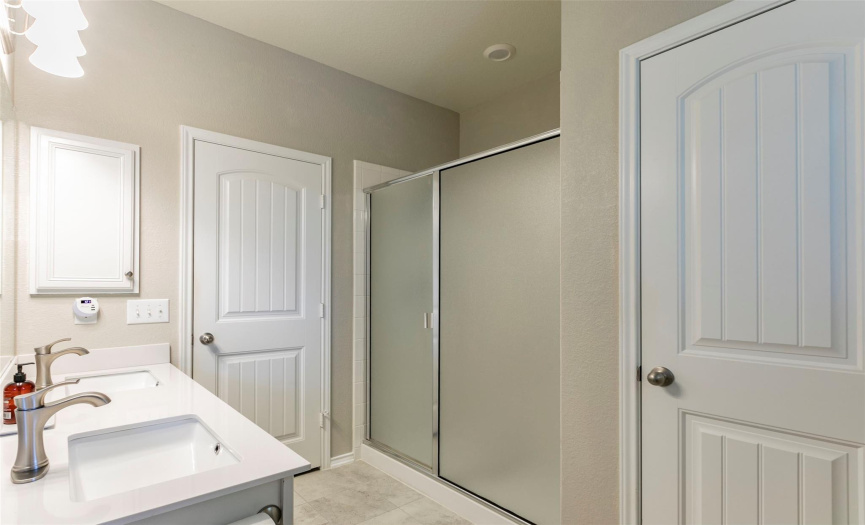 A large walk-in shower and linen closet complete the primary bath.