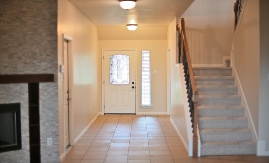 The entryway offers generous space, welcoming guests with its expansive layout.