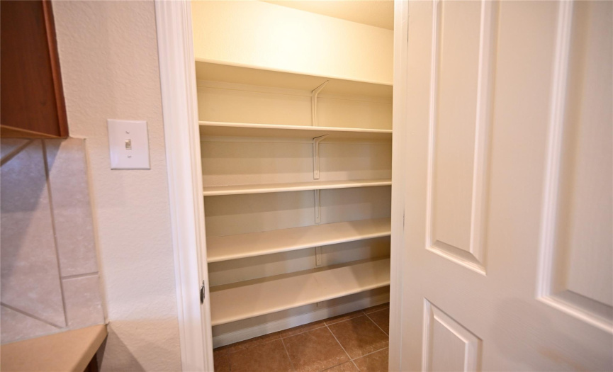 Indulge in the convenience of a spacious walk-in pantry, offering abundant storage for all your food items and beyond.