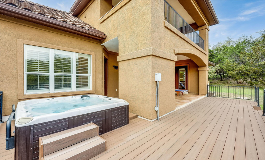 The rear deck hosts a hot tub, the perfect place to relax!