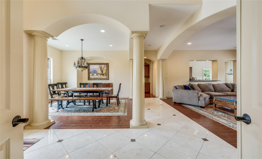 The entry foyer is open to the formal dining and living area.  Notice the arches