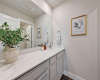 This large bathroom also has ample storage and separated commode.