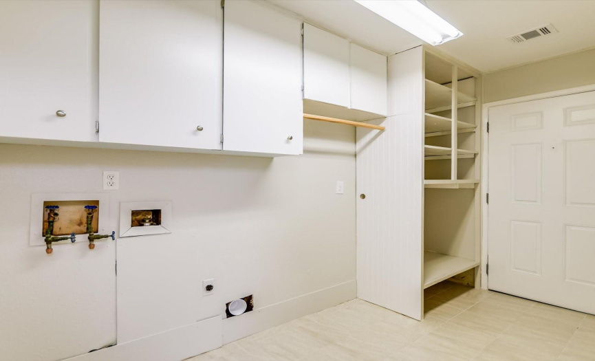 Ample storage in this utility room on both sides