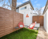 Patio with artificial grass and steps that lead to the tiny home