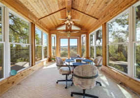 Private glass-enclosed sunroom off of primary suite.