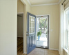 Beautiful front door with storm door allows for plenty of natural light to enter