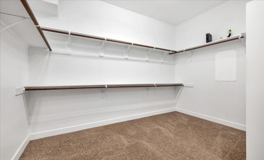 One area of the primary walk-in closet.