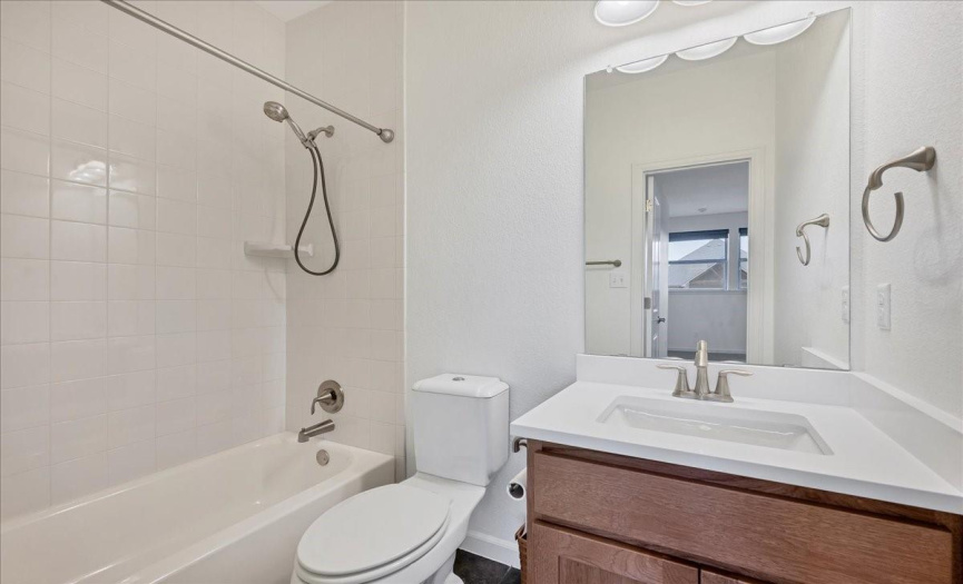 The half bathroom is located toward the front of the home near the office.