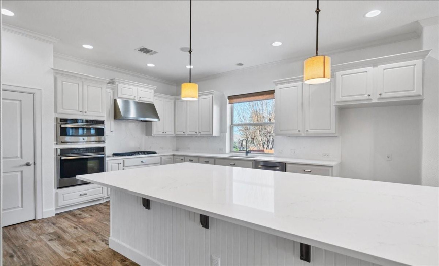 The kitchen has been beautifully updated with stunning quartz counters and backsplash, along with fresh paint.