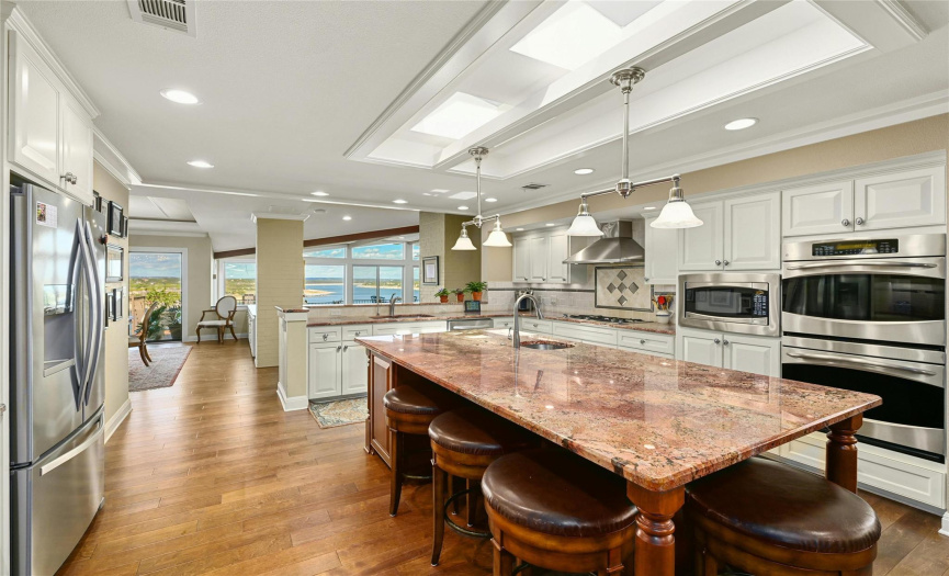 The kitchen has a huge center island and lots of natural light...plus that same view of the lake