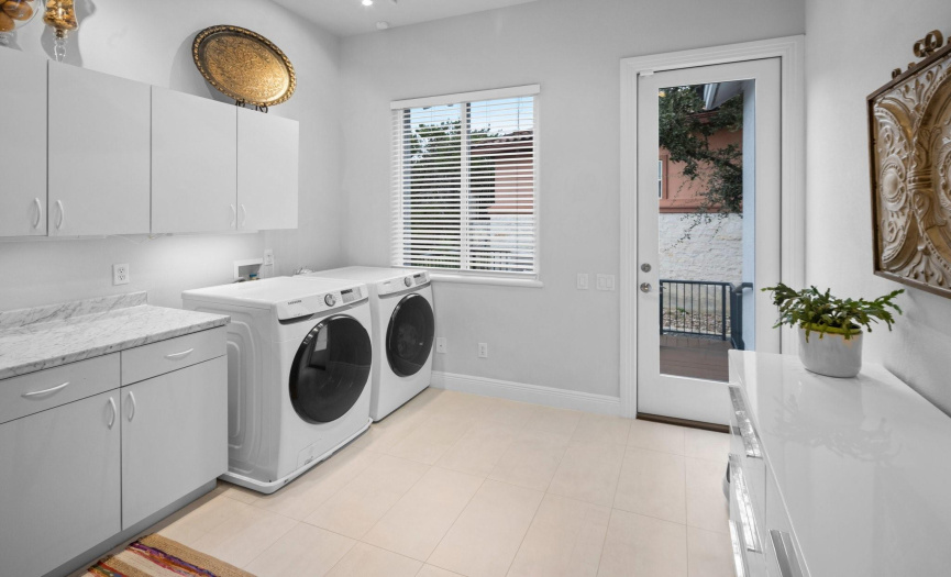 Luxurious laundry room off the garage. Second laundry room located upstairs. 