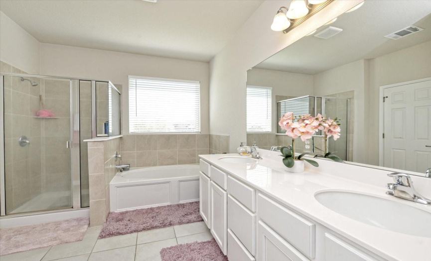 A double vanity separate walk-in shower and garden tub will be a great place to start the day