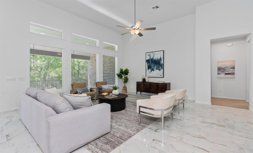 Living room features beautiful porcelain floors and tall ceilings. 