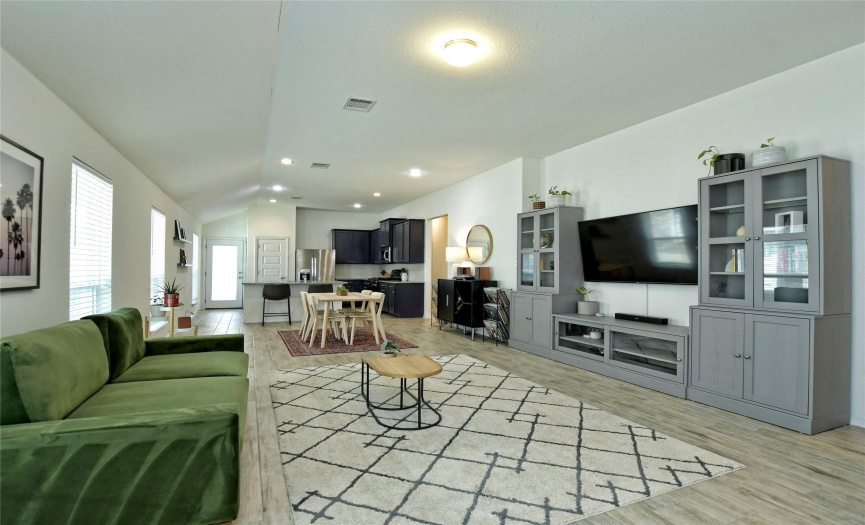 Your living area, dining space, and kitchen in an open layout. View from the open front door.