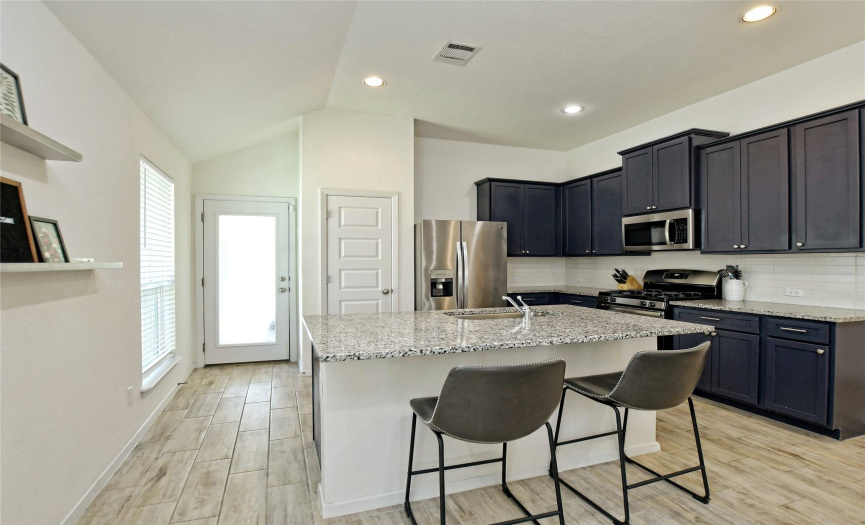 Kitchen with large island. Provides cooking area for the sous chef in your life and morning breakfast spot!