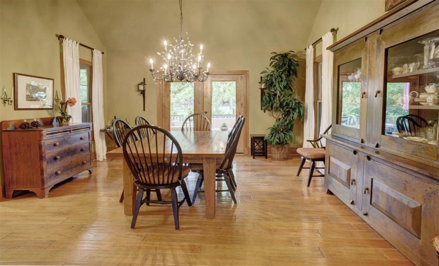 Entertain in the spacious formal dining area with cathedral ceilings, seamlessly connected to the back deck and positioned between the living area and butler's pantry