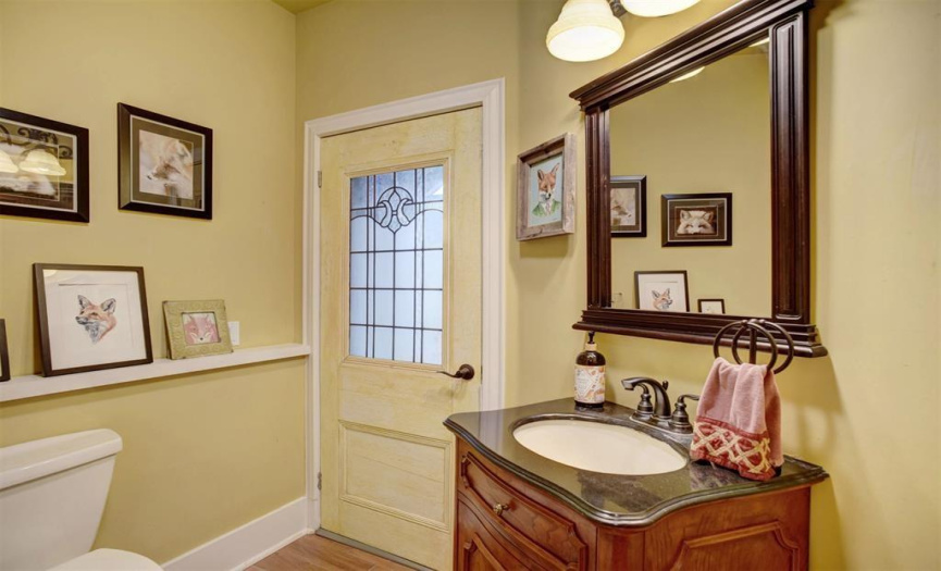 Guest bath just off the dining area in the butlers pantry, also has access to the front porch