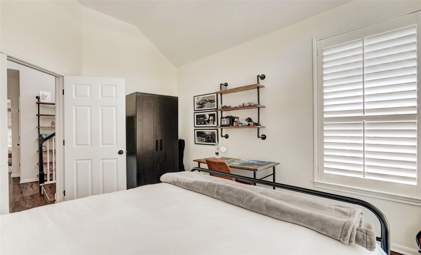 Alternate view of the first floor bedroom/office.  Notice the beautiful plantation shutters, a custom upgrade you'll find throughout the home.