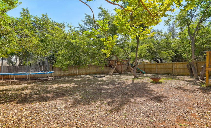 Escape into your own private oasis with this expansive backyard retreat, adorned with majestic mature oak trees that provide shade and tranquility. Perfect for outdoor enthusiasts, this lush haven boasts a charming playhouse plenty of room for a trampoline (or pool!), offering endless opportunities for recreation and fun-filled adventures.