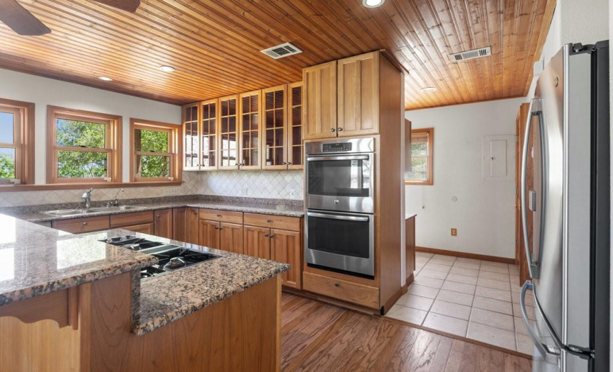 DOUBLE OVENS AND KITCHEN LEADS TO LAUNDRY AND A WET BAR