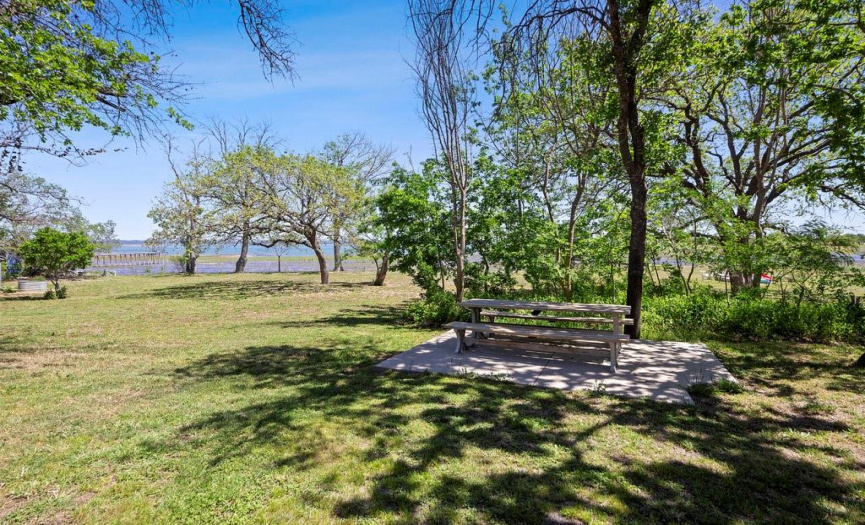 ENJOY THE LARGE TREE LINED BACKYARD DOWN TO THE LAKE. 