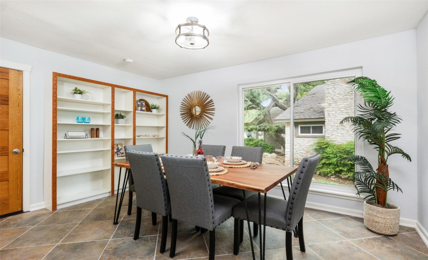 Dining area has a large glass window and built in shelving