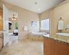 Pamper yourself in style in this lavish ensuite bath, featuring decadent amenities for a blissful self-care experience