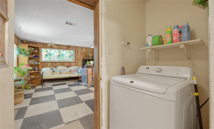 Laundry area is situated between the kitchen & flex space