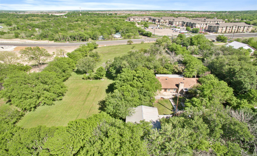 Looking from the back of the property to Dacy Ln. The open grassy area to the left of the house in this shot is also part of this 2.112 acre tract.