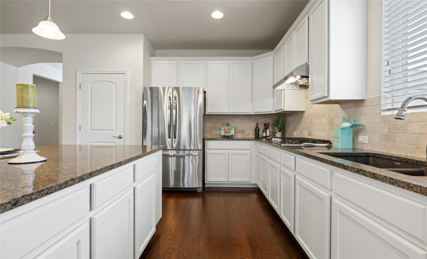 Modern-feel kitchen with neutral brick backsplash in your open kitchen.
