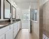 Main bedroom en-suite with granite counter dual vanity and walk-in shower.