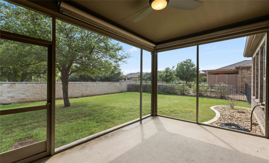 Screened back patio with views of your fully fenced back yard.