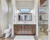 A large walk-in shower along with plenty of cabinets and more natural light from elevated privacy windows.